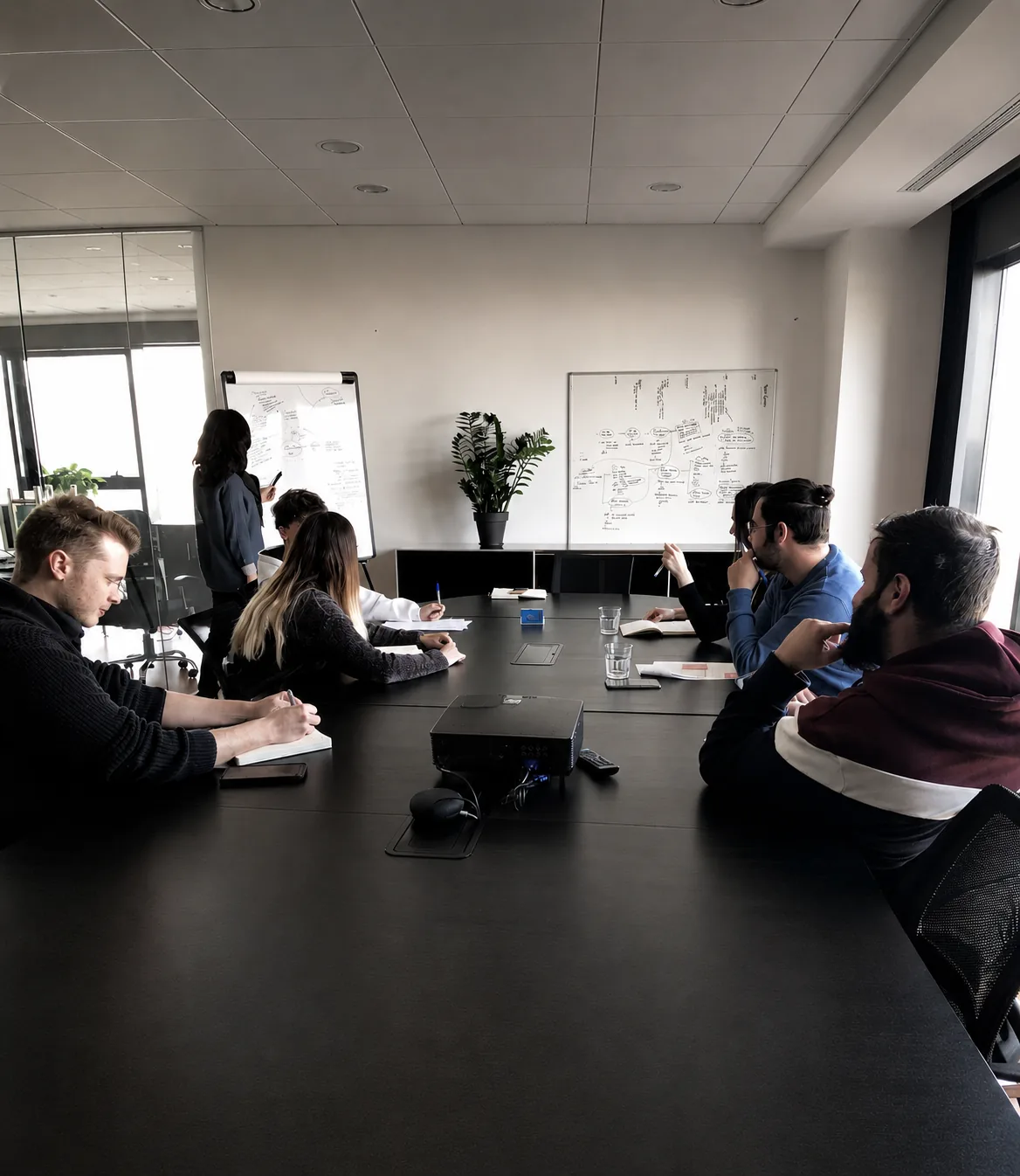Dexis team in a conference room workshop with whiteboards and collaborative planning